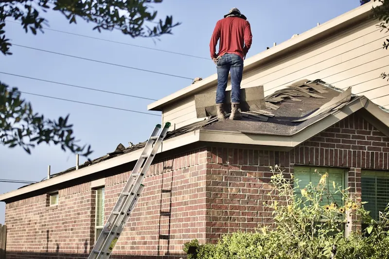 Professional roofer working on a residential roof in Westchester